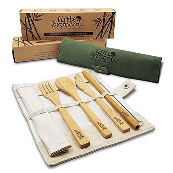 A natural colour bamboo cutlery pouch is open on the table and the cutlery set lays on top. There is a green pouch in the background.