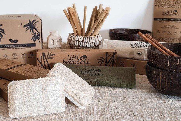 A group picture of he entire range of products from little broccoli including coconut bowls, bamboo cutlery, bamboo straws and loofah and cellulose biodegrable washing up sponges