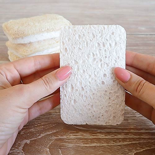 close up image of natural loofah sponge in a womans hands
